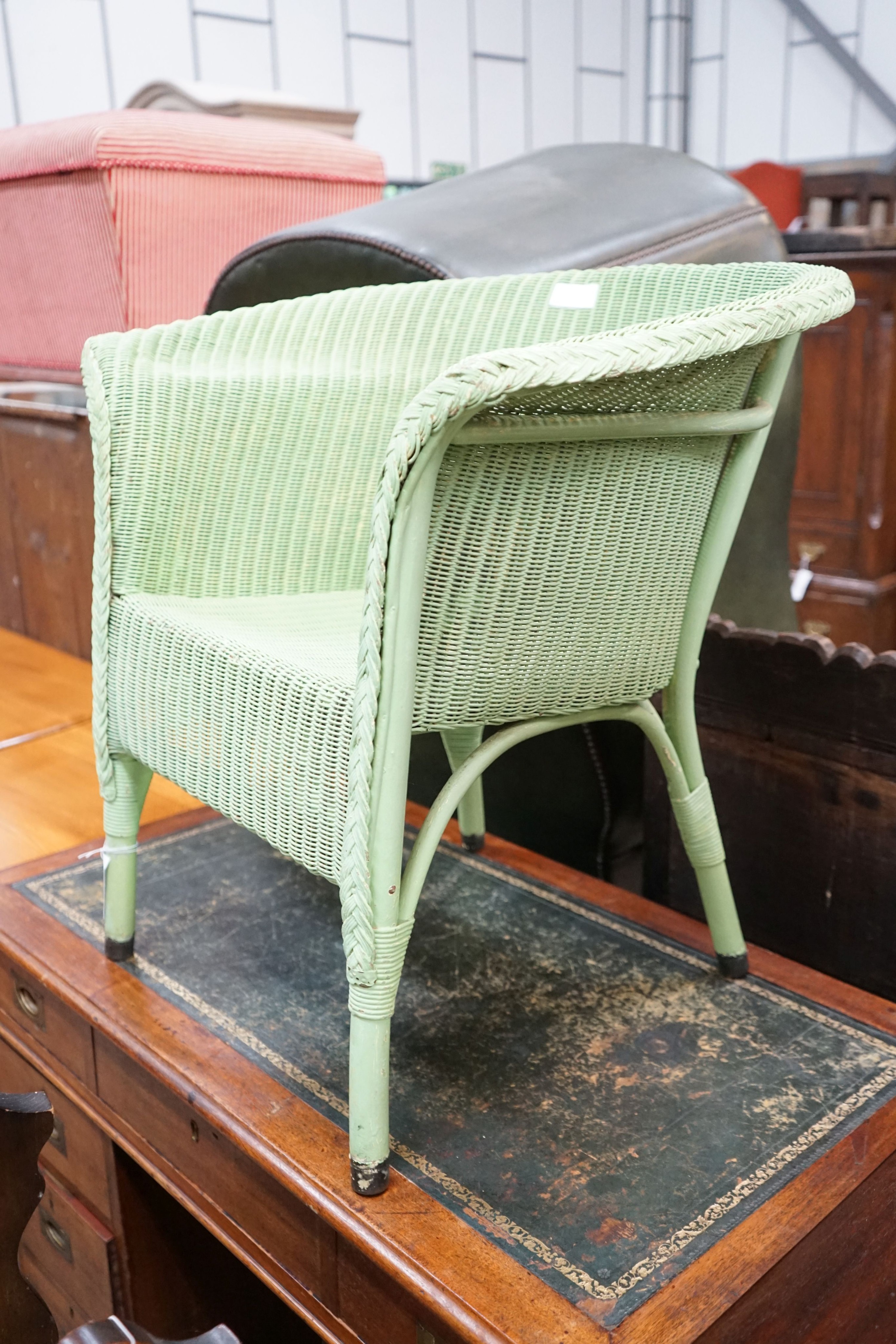 A Lloyd Loom elbow chair, later painted